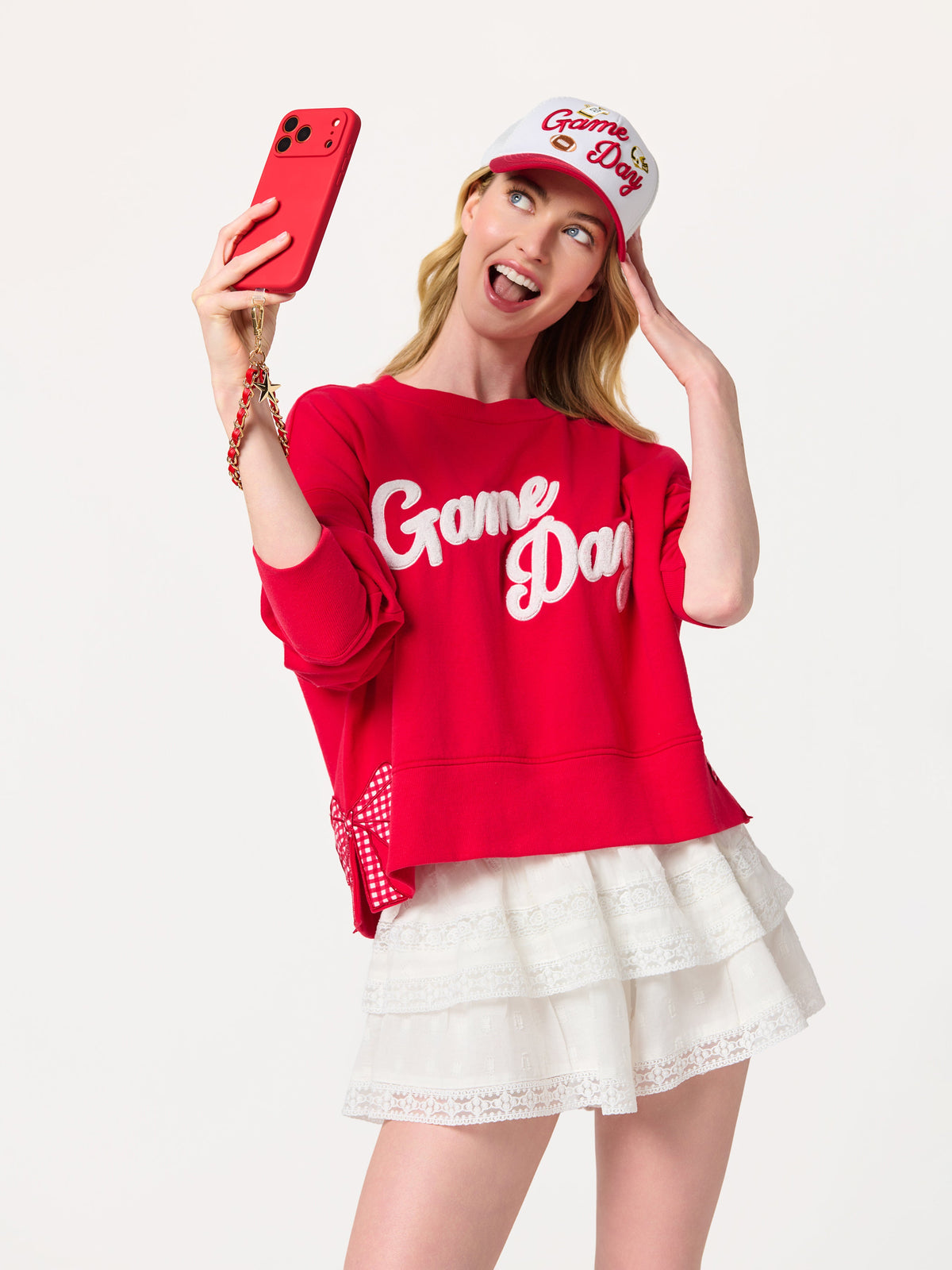 Taylor Football and Star Phone Wristlet with Chain Link Strap, shown in a styled setting