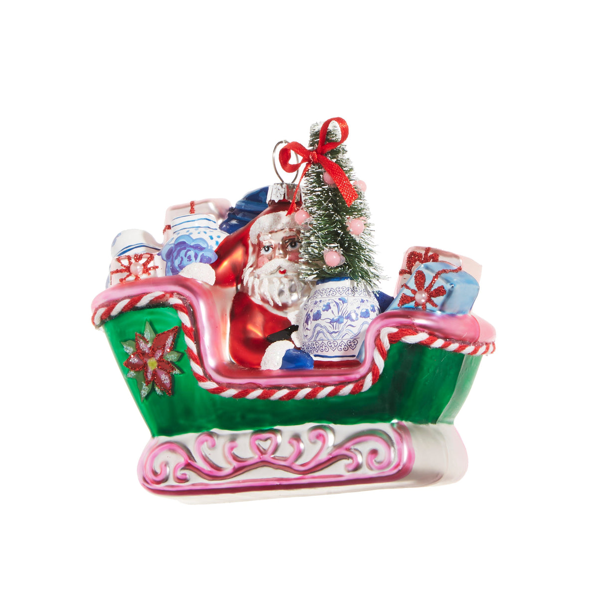 Chinoiserie Sleigh Ride Ornament, A glass sleigh ornament with Santa, a wrapped poinsettia, a bottle brush tree, and a blue and white porcelain vase riding among the gifts.