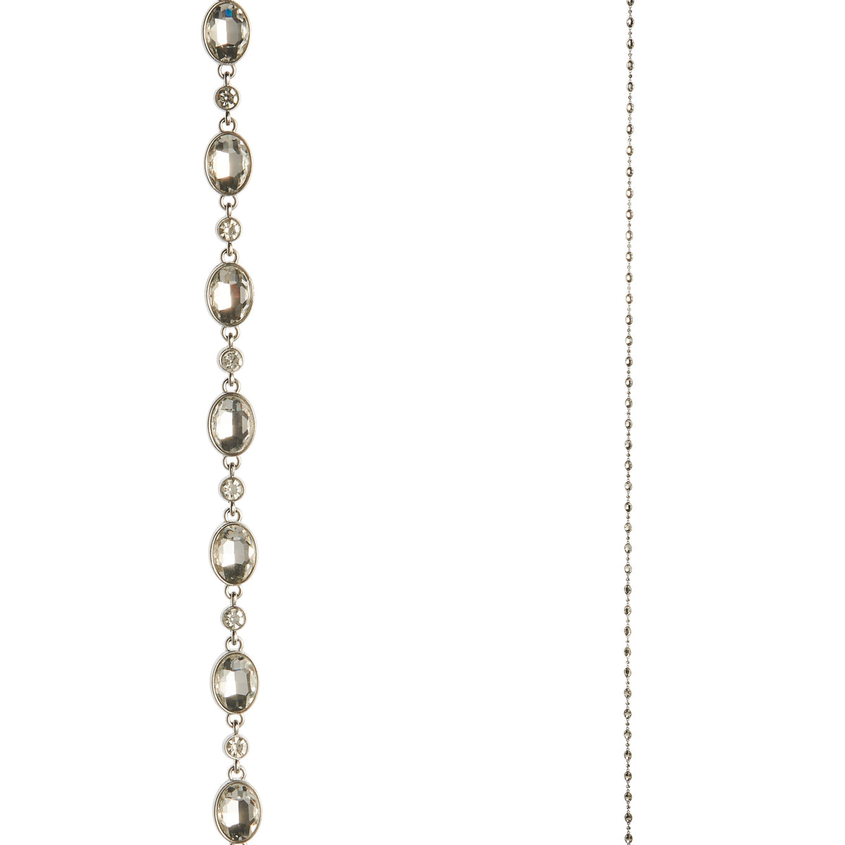 Crystal Garland, The photo shows a strand of faceted clear crystals in oval silver settings running alongside a fine beaded metal chain.