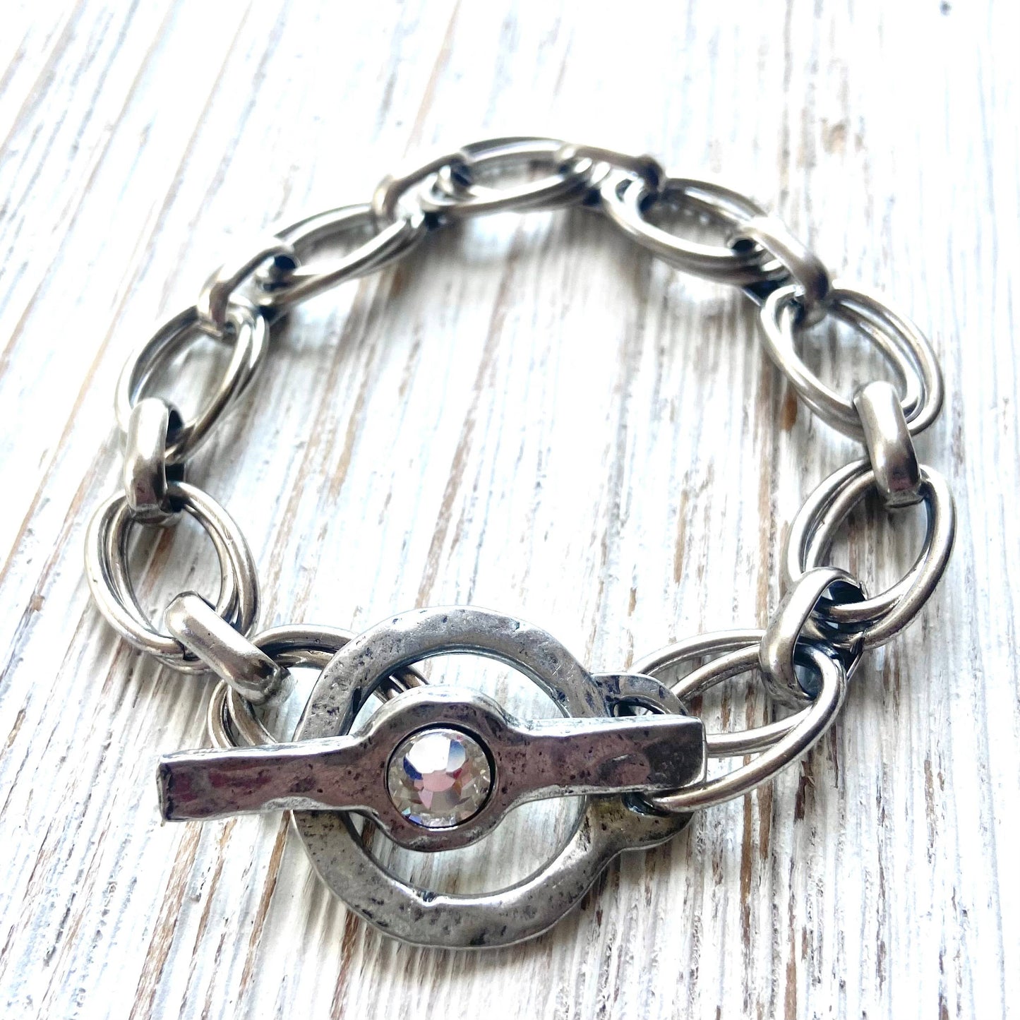 Pulsera gruesa martillada y fundida a mano con cristal.