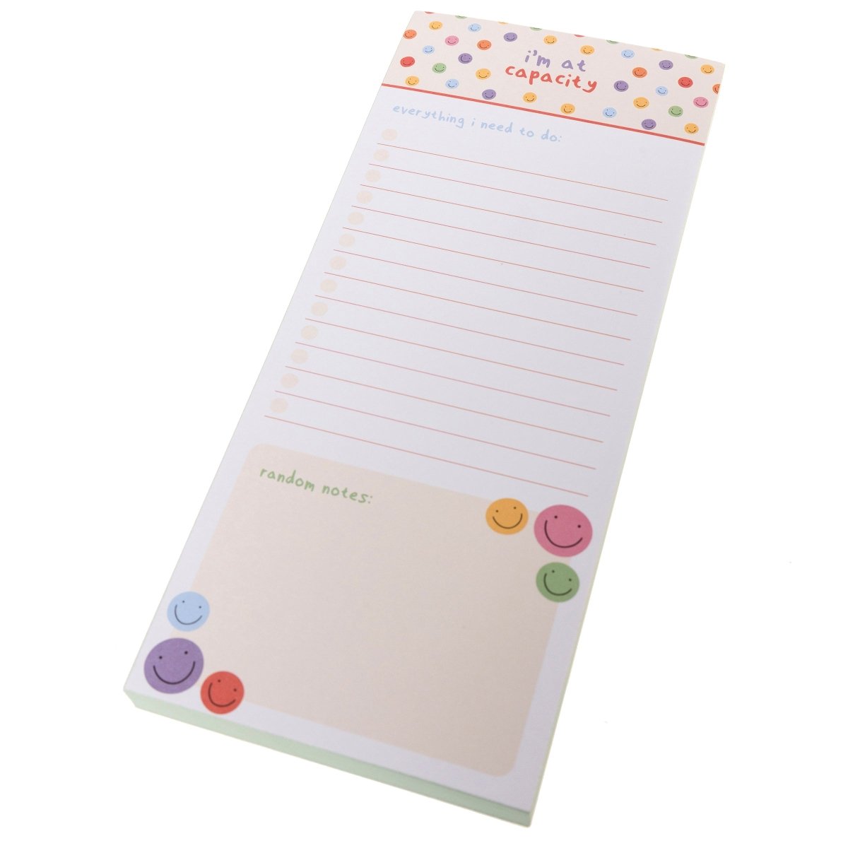 I'm At Capacity Magnetic Notepad, A tall magnetic notepad printed 'i'm at capacity' with colorful smiley polka dots above a lined checklist and a 'random notes' section.