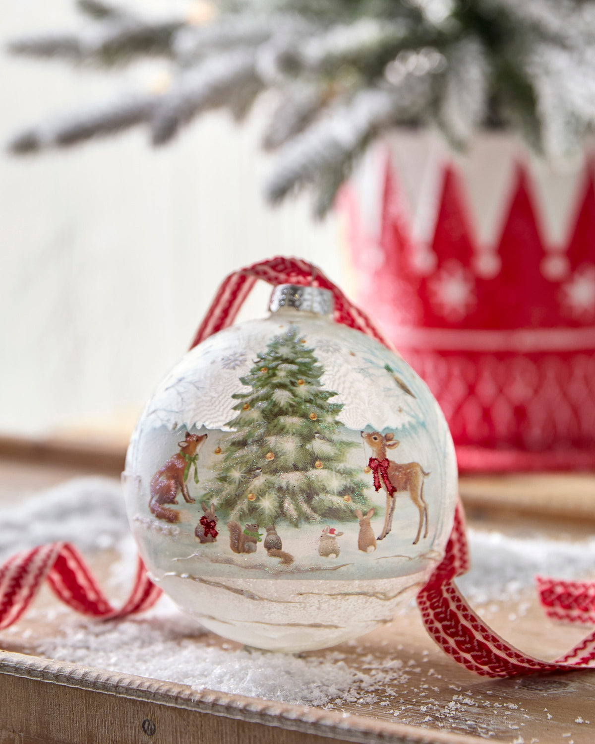 Woodland Christmas Party Ball Ornament, A round glass ornament illustrated with a woodland scene of a fox, deer, rabbits, squirrel and bird gathered around a glittered Christmas tree.