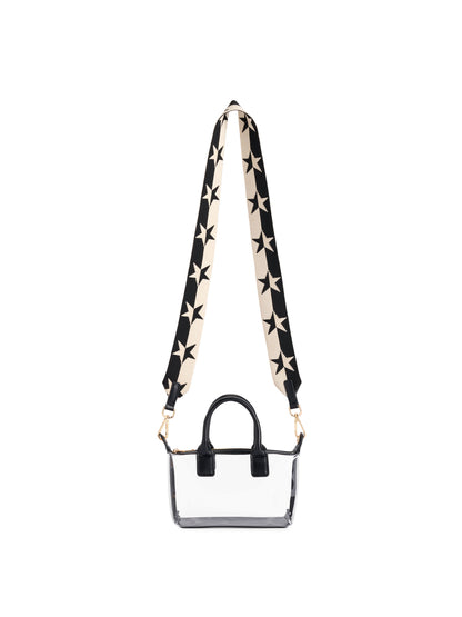 Spectator Clear Stadium Top Handle Cross-Body Bag, Black, A clear PU bag with black handles and gold hardware, with a long black and cream star-patterned strap hanging above it.