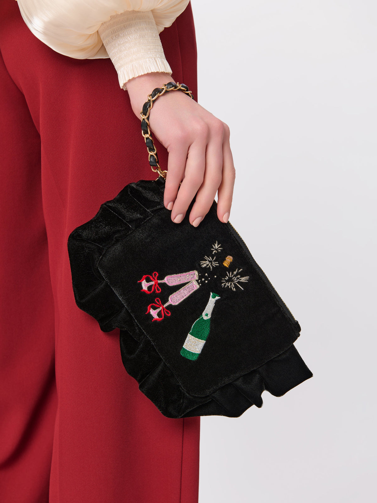 Pop Velvet Wristlet with Champagne Embroidery, Black, shown in a styled setting
