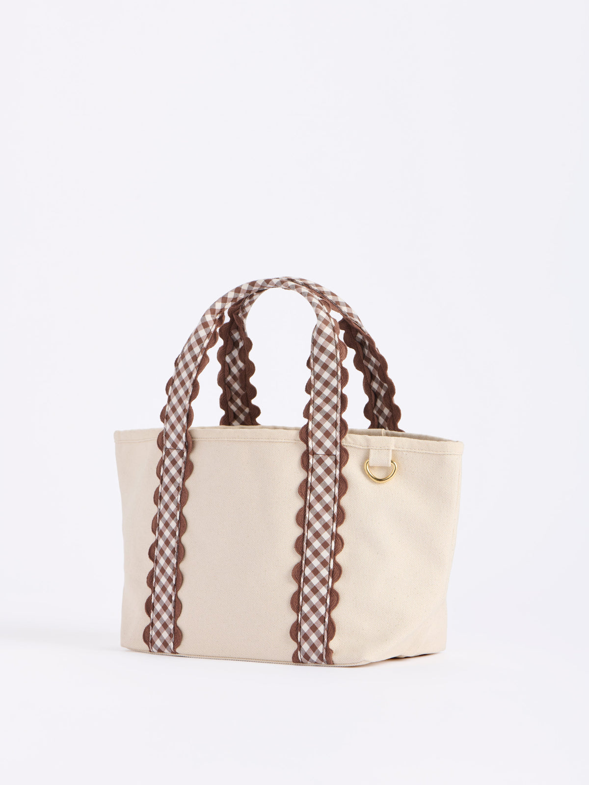 Darling Gingham Strap Canvas Mini Tote, Brown, A cream canvas mini tote with brown and white gingham handles edged in brown scalloped trim and a gold D ring on the side.
