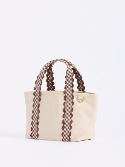 Darling Gingham Strap Canvas Mini Tote, Brown, A cream canvas mini tote with brown and white gingham handles edged in brown scalloped trim and a gold D ring on the side.