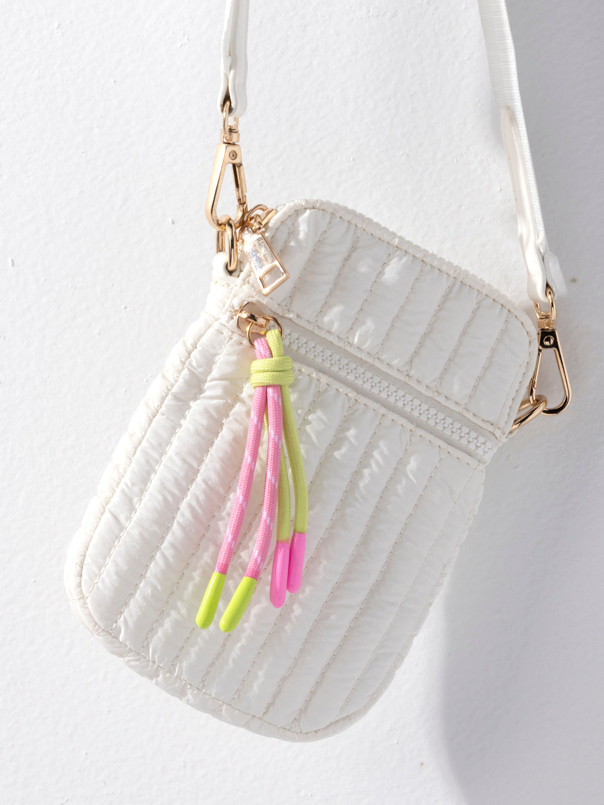 Logan Shiny Quilted Nylon Phone Holder Crossbody Bag, shown in a styled setting