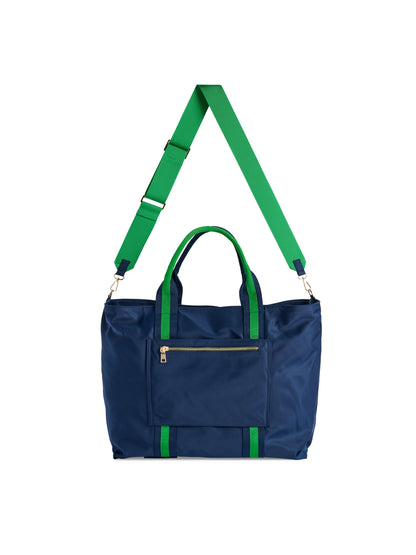 Jet Travel Tote with Cross-Body Strap, A black tote with two top handles, a long black cross-body strap, a front zip pocket and a cream knotted tassel on the zipper pull.