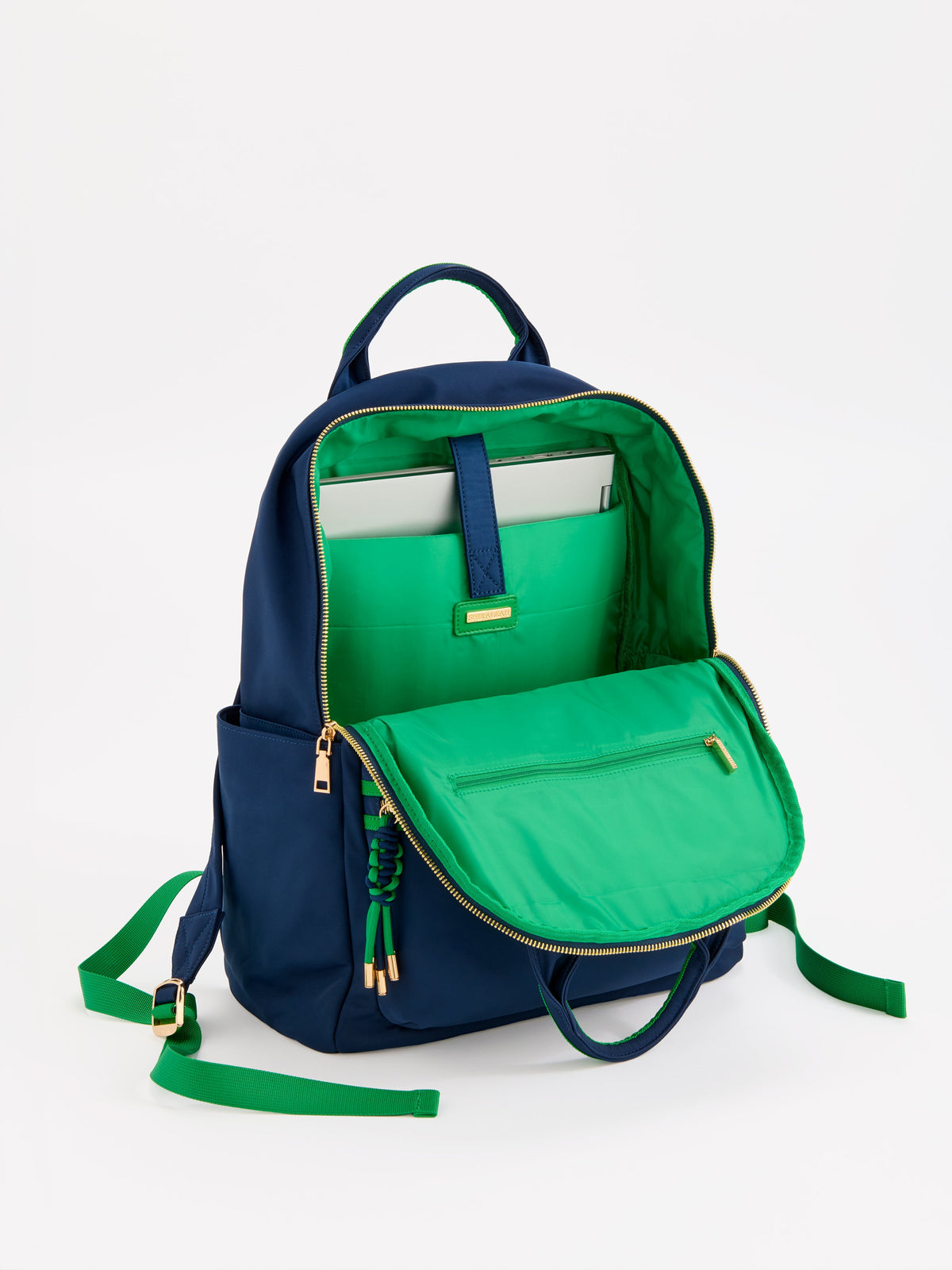 Jet Backpack with Inner Tech Sleeve, A navy backpack with bright green handles and zipper trim, a front zip pocket, side pockets and a green and navy tassel zipper pull.
