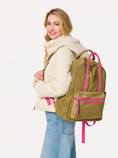 Jet Backpack with Inner Tech Sleeve, A navy backpack with bright green handles and zipper trim, a front zip pocket, side pockets and a green and navy tassel zipper pull.