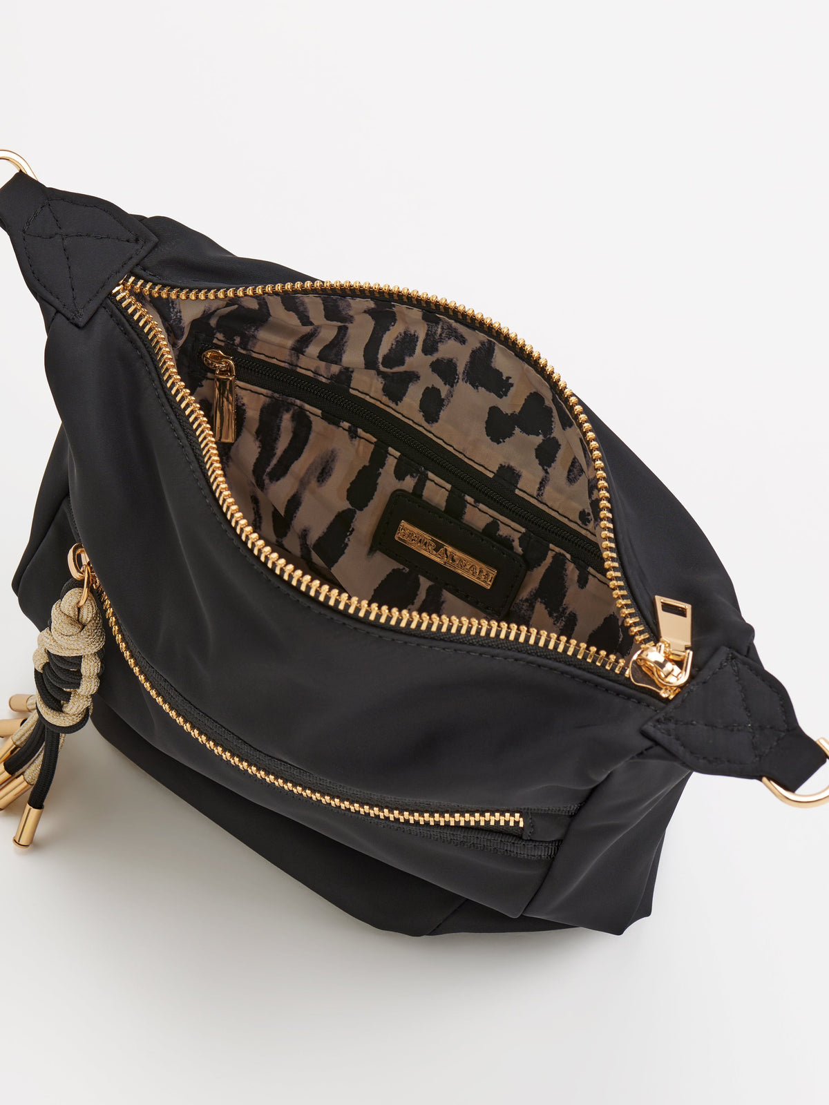 Jet Convertible Cross-Body Bag with Top Handles, shown in a styled setting