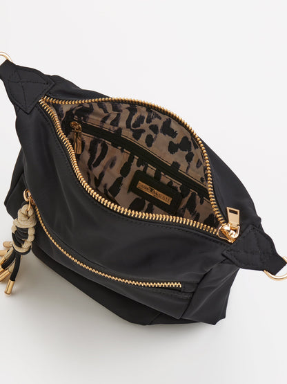 Jet Convertible Cross-Body Bag with Top Handles, shown in a styled setting