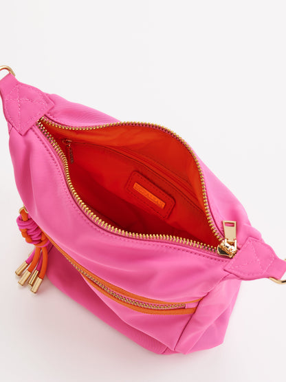 Jet Convertible Cross-Body Bag with Top Handles, shown in a styled setting