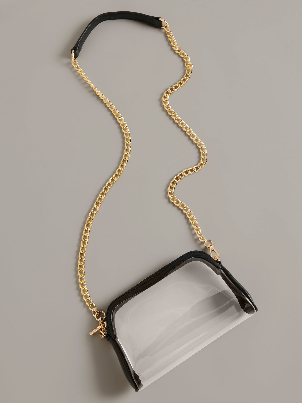 Taylor Clear Cross-Body Bag with Gold Chain Strap, Black, shown in a styled setting