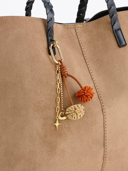 Pom Pom Bag Charm and Key Ring, Ivory, shown in a styled setting