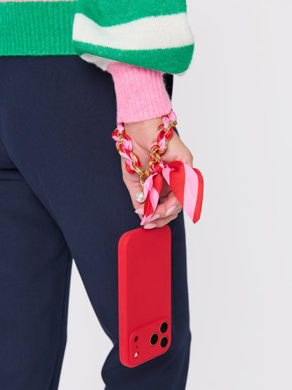 Phone Wristlet with Scarf Bow and Gold-Tone Chain, shown in a styled setting