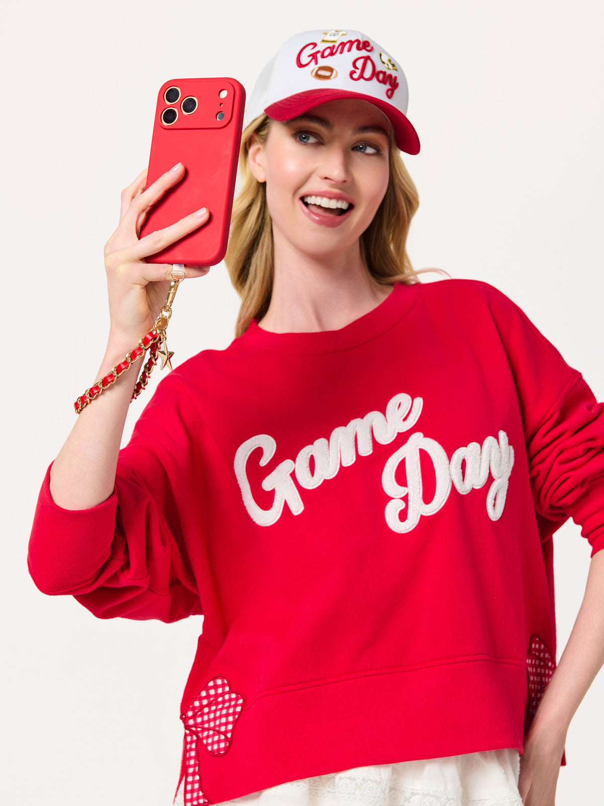 Taylor Football and Star Phone Wristlet with Chain Link Strap, shown in a styled setting
