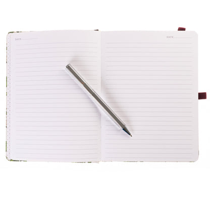 La Petite Presse Cerise Fabric-Bound Journal with Pen, An ivory fabric journal printed with botanical cherries and blossom sprigs, closed with a burgundy elastic band and a silver pen tucked into a loop.