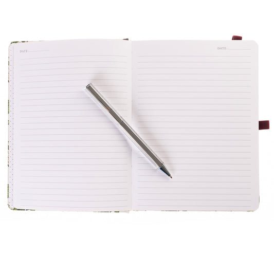 La Petite Presse Cerise Fabric-Bound Journal with Pen, An ivory fabric journal printed with botanical cherries and blossom sprigs, closed with a burgundy elastic band and a silver pen tucked into a loop.