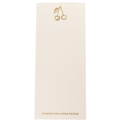 La Petite Presse Cherries Gilded Desktop Notepad, A cream notepad with gold foil cherries at the top and the words Cherish the Little Things stamped in gold at the bottom.