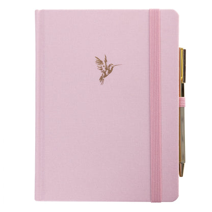 La Petite Presse Hummingbird Fabric-Bound Journal with Pen, A pink fabric journal with a gold foil hummingbird on the cover, paired with a gold twist pen tucked into a loop at the spine.