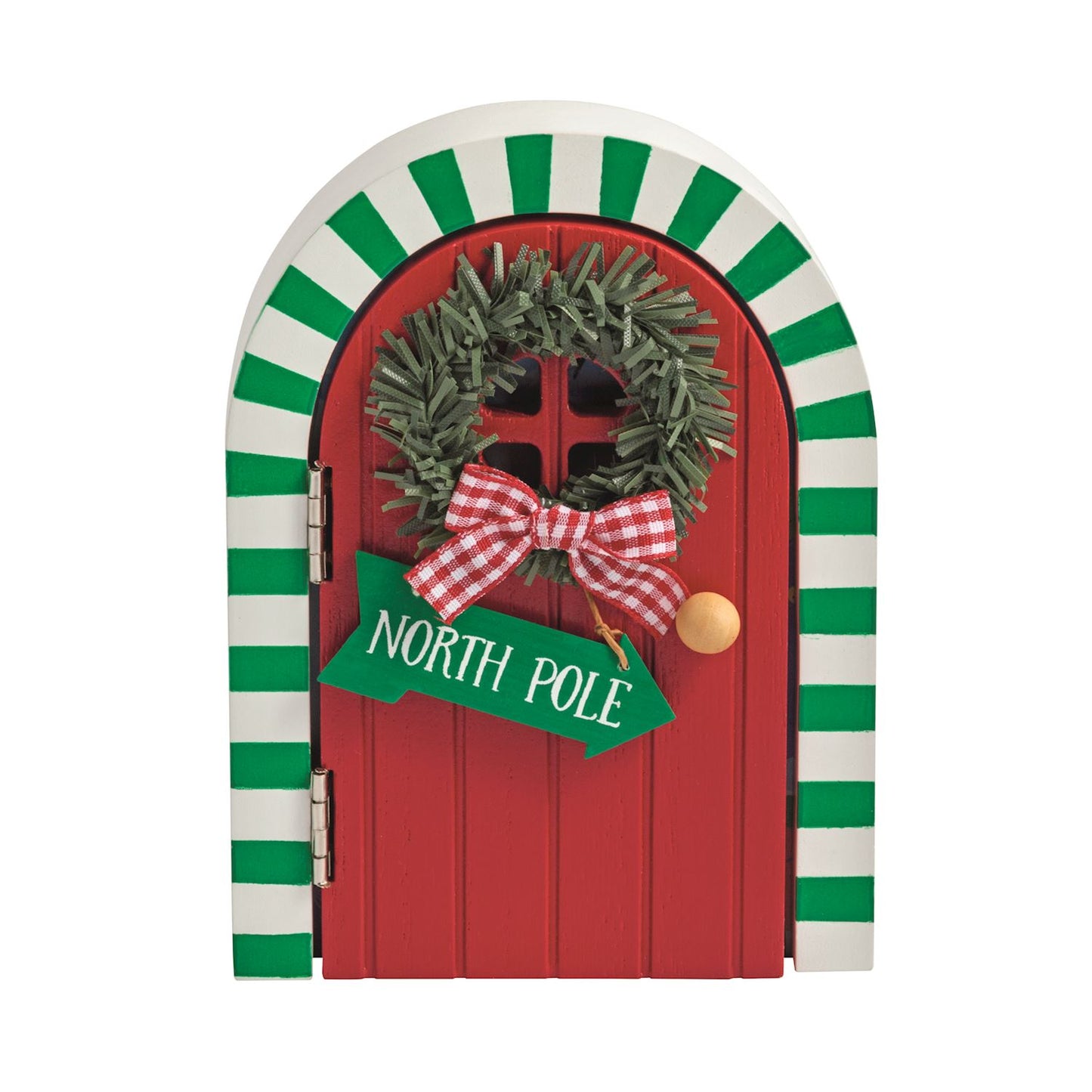 Light-Up Wooden Magic Elf Door, 5 Inch, An arched wooden elf door with a red front panel, a cut-out window and a printed verse, standing in front of a painted winter scene of Santa and an elf lit by small stars.