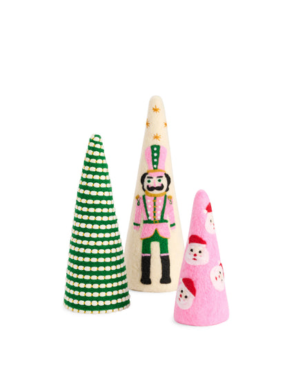 Felt Decorative Christmas Tree, Three felt cone trees on white: a green tree striped with cream beading, a cream tree with a pink and green nutcracker, and a pink tree with Santa faces.
