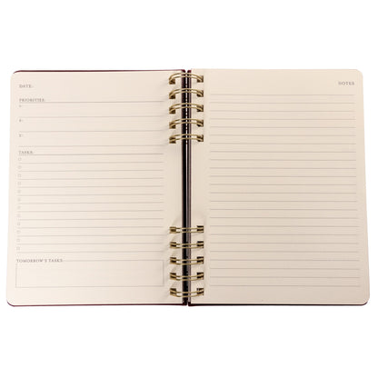 Burgundy Fabric-Bound Task Journal, A burgundy fabric-covered task journal with gold twin wire spirals and two maroon ribbon bookmark tabs, closed with an elastic band.