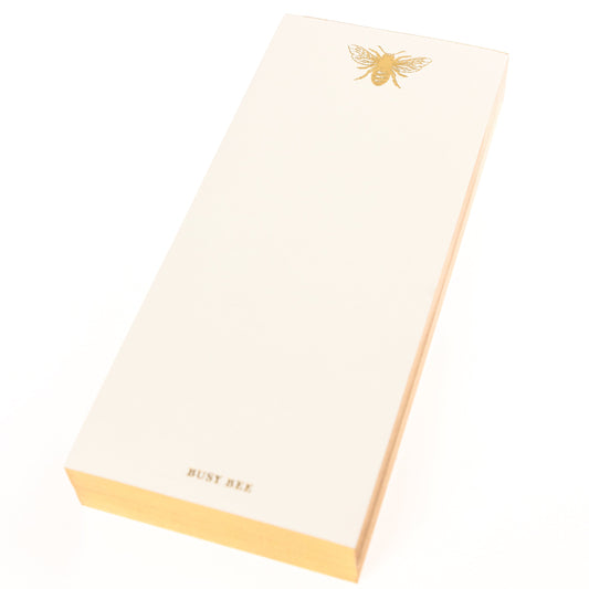 La Petite Presse Bee Gilded Desktop Notepad, A cream notepad with a gold foil bee at the top and the words Busy Bee stamped in gold at the bottom, with a gold gilded edge.