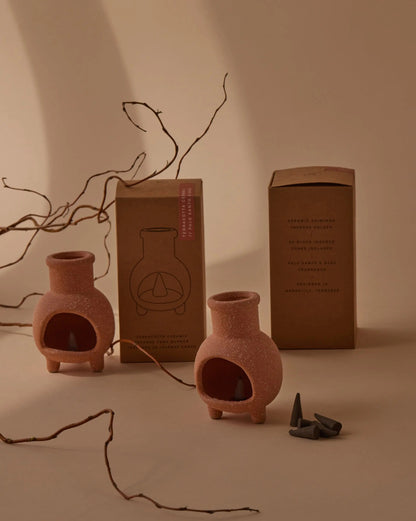 Palo Santo & Sage Chiminea Incense Holder, A terracotta ceramic chiminea shaped incense holder standing next to its kraft packaging box labeled Palo Santo and Sage.