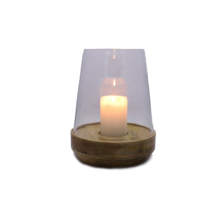 Grove Glass Hurricane Candle Holder, A clear glass dome candle holder on a round natural wood base, shown lit with a pillar candle inside.