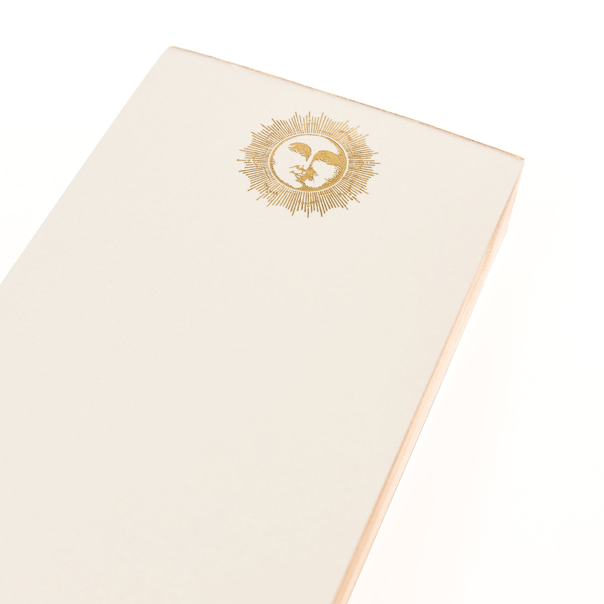 La Petite Presse Sun Gilded Desktop Notepad, A cream notepad with a gold foil sun and face design at the top and the words Look on the Bright Side stamped in gold at the bottom.