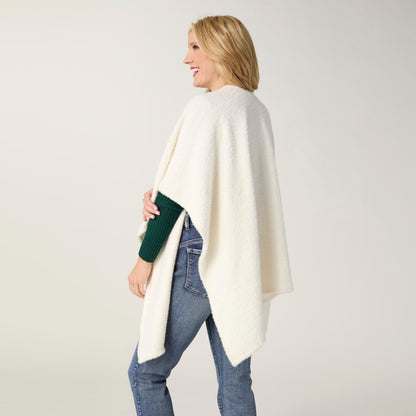 Elaina Tinsel Pull-Through Wrap, A smiling woman wears a soft white textured knit ruana wrap with one end pulled through a front loop into a twisted knot.