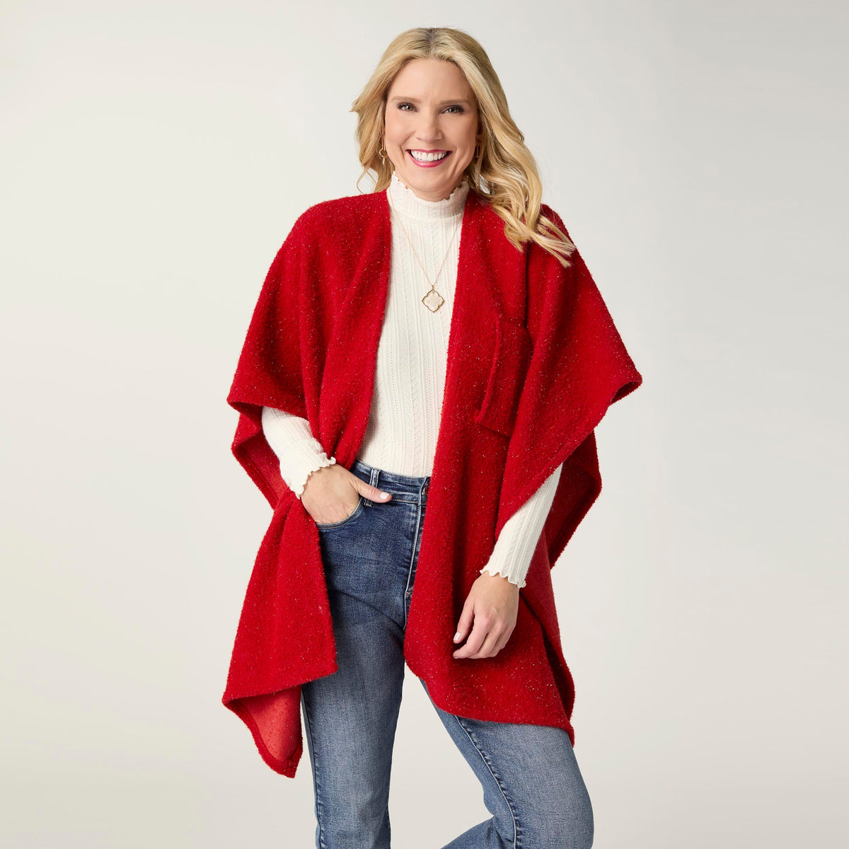 Elaina Tinsel Pull-Through Wrap, A smiling woman wears a soft white textured knit ruana wrap with one end pulled through a front loop into a twisted knot.