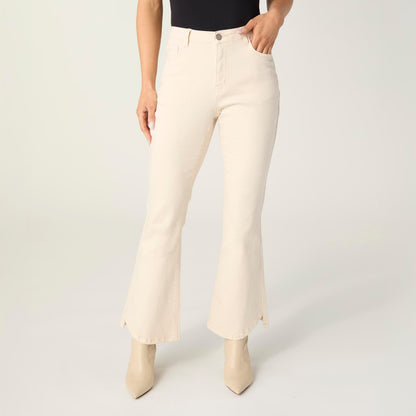 Willa Curved Hem Flare Pant, A woman's lower half in cream flare pants with a curved hem and pointed cream ankle boots.