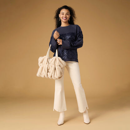 Willa Curved Hem Flare Pant, A woman's lower half in cream flare pants with a curved hem and pointed cream ankle boots.