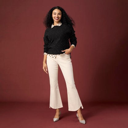 Willa Curved Hem Flare Pant, A woman's lower half in cream flare pants with a curved hem and pointed cream ankle boots.