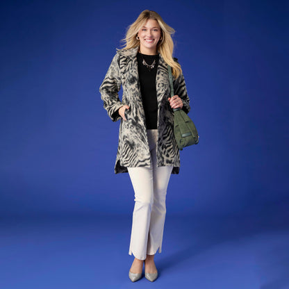 Willa Curved Hem Flare Pant, A woman's lower half in cream flare pants with a curved hem and pointed cream ankle boots.