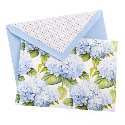 La Petite Presse Hortensia Boxed Correspondence Notes, A brown gift box open to a white notecard printed with powder blue hydrangea blooms, paired with a matching blue envelope.