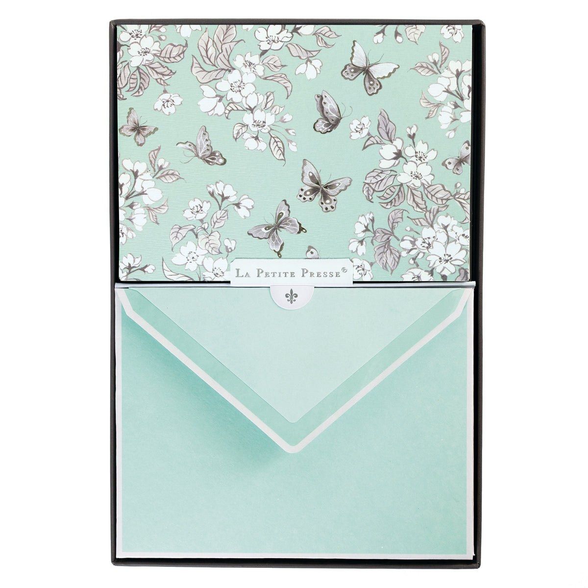 La Petite Presse Butterflies Boxed Correspondence Notes, A brown gift box open to reveal a seafoam green notecard with silver-foiled butterflies and cherry blossoms, paired with a matching mint envelope.