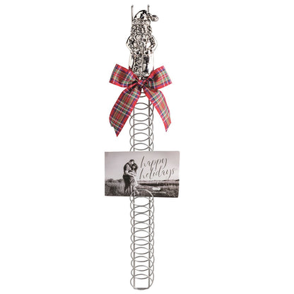 Santa Topper Metal Coil Christmas Card Holder, 23.5 Inch, A tall silver-tone metal coil card holder with a cast aluminum Santa figure at the top and a holiday photo card tucked between the rings.