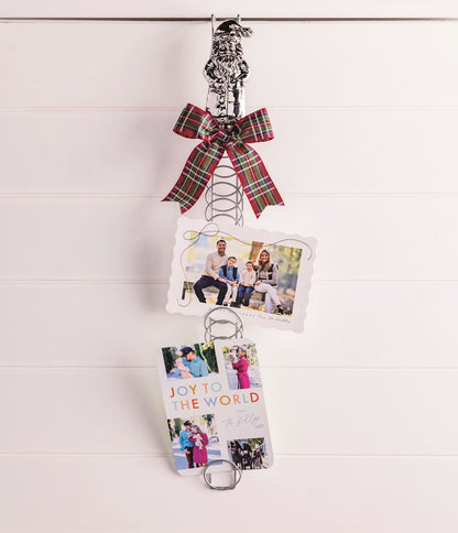 Santa Topper Metal Coil Christmas Card Holder, 23.5 Inch, A tall silver-tone metal coil card holder with a cast aluminum Santa figure at the top and a holiday photo card tucked between the rings.