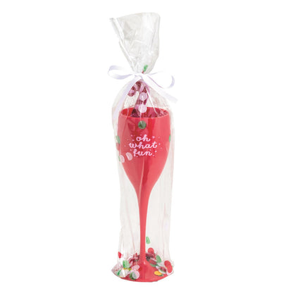 Oh What Fun Acrylic Champagne Flute Set, Red acrylic champagne flute lettered oh what fun in white script, packed with a pink glitter drink stirrer in a clear cello sleeve of red and green confetti tied with a white ribbon.