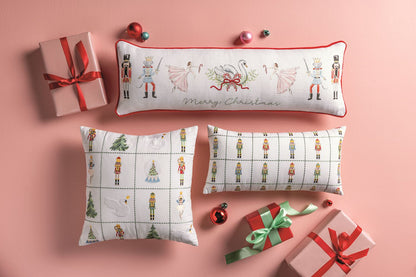 Nutcracker Merry Christmas Long Pillow, Long white pillow with red velvet piping, painted with nutcracker soldiers, crowned mice with swords, pink ballerinas and a swan in a wreath, and Merry Christmas in green script.