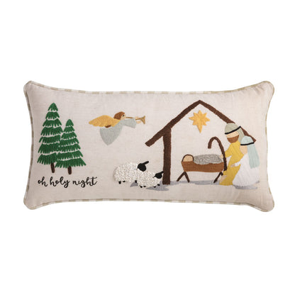 Oh Holy Night Nativity Embroidered Pillow, A cream lumbar pillow embroidered with a nativity scene of green firs, an angel with a trumpet, two sheep, and Mary and Joseph at the manger under a gold star, with oh holy night stitched at the left and tan gingham piping.