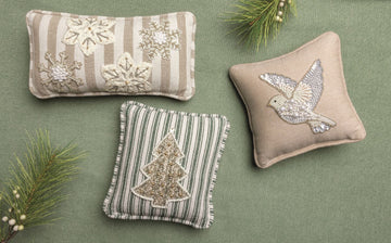 Beaded Turtle Dove Mini Pillow, A small square pillow in natural woven fabric with a piped edge, fronted by a flying dove worked in white pearls, seed beads and clear sequins.