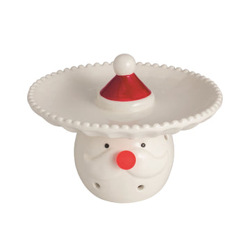 Santa Light-Up Candy Pedestal Dish, 5.5 Inch, A white ceramic pedestal dish with a beaded rim and a small red Santa hat at its center, resting on a base shaped like a Santa face with a red nose and molded moustache.