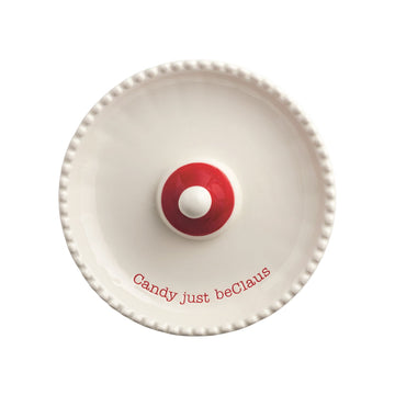 Santa Light-Up Candy Pedestal Dish, 5.5 Inch, A white ceramic pedestal dish with a beaded rim and a small red Santa hat at its center, resting on a base shaped like a Santa face with a red nose and molded moustache.