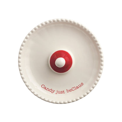 Santa Light-Up Candy Pedestal Dish, 5.5 Inch, A white ceramic pedestal dish with a beaded rim and a small red Santa hat at its center, resting on a base shaped like a Santa face with a red nose and molded moustache.