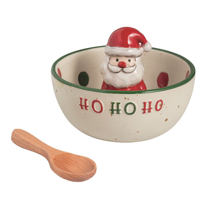 Santa Ho Ho Ho Candy Bowl and Wooden Spoon Set, A cream speckled stoneware bowl with a green rim, raised red and green HO HO HO lettering and a Santa figure rising inside, shown beside a small wooden spoon.